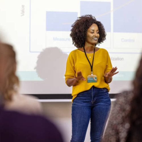 African businesswoman sharing statistics and growth rate during a conference. Female entrepreneur presenting at business seminar.